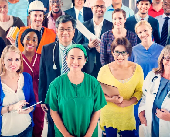 A group of individuals wearing various work uniforms standing together.